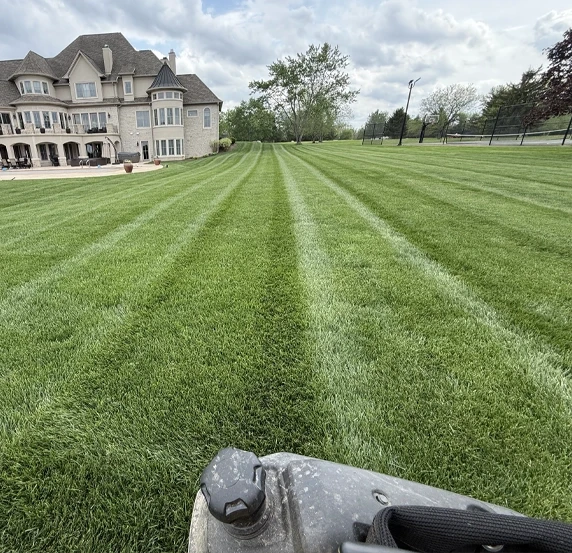Residential lawn mowing with perfect stripes on large estate property in Center Grove Indiana by Grant Keys Lawn Care